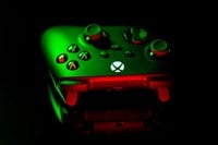 January 9, 2023, Odessa, Ukraine. A black Xbox Wireless Controller highlighted in green and red. Compatible Xbox Series X|S, Xbox One on a dark background.